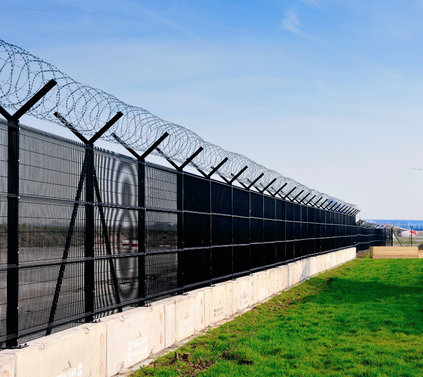 Razor barbed wire mounted on welded wire mesh panels